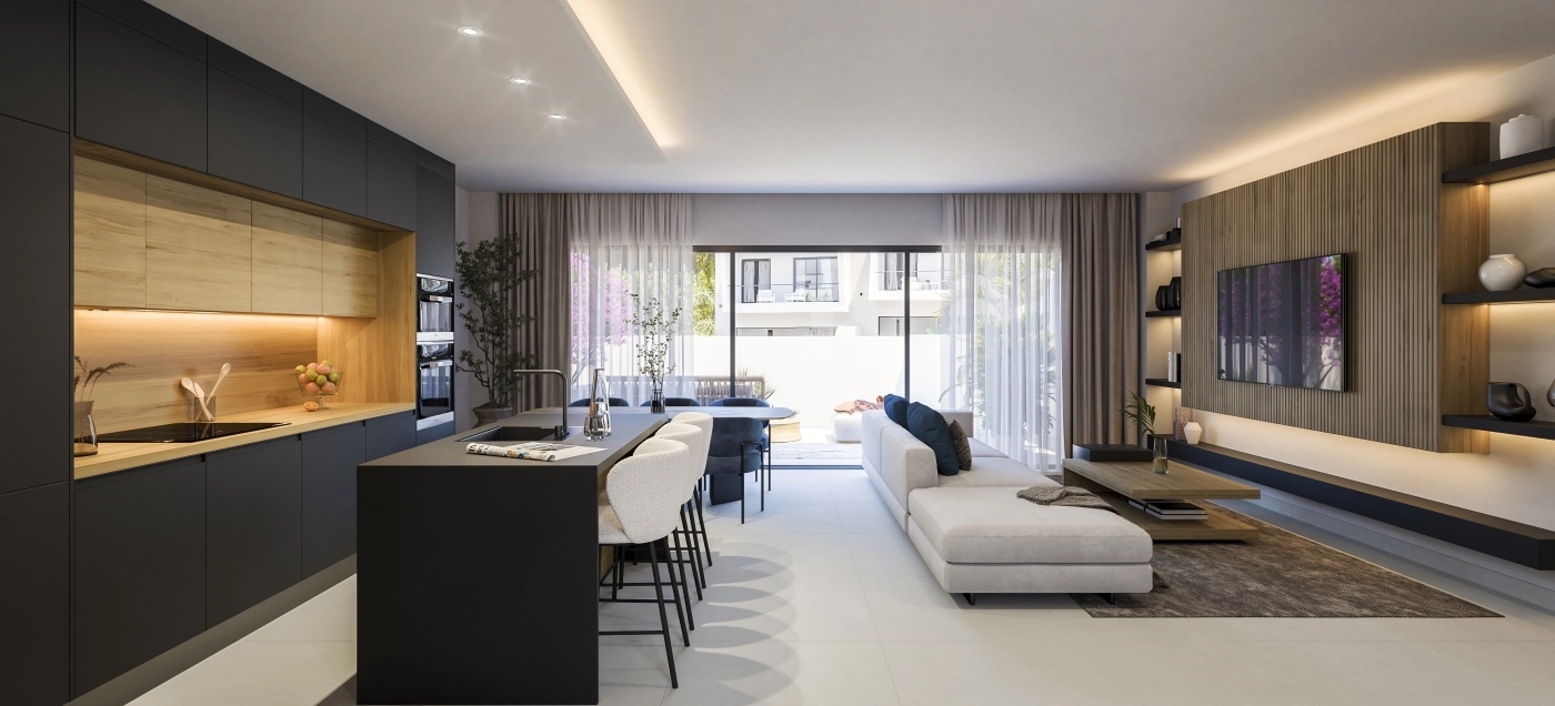 Det åbne opholdsrum kombinerer køkken-, spise- og stueområderne for en sømløs, moderne livsstil.