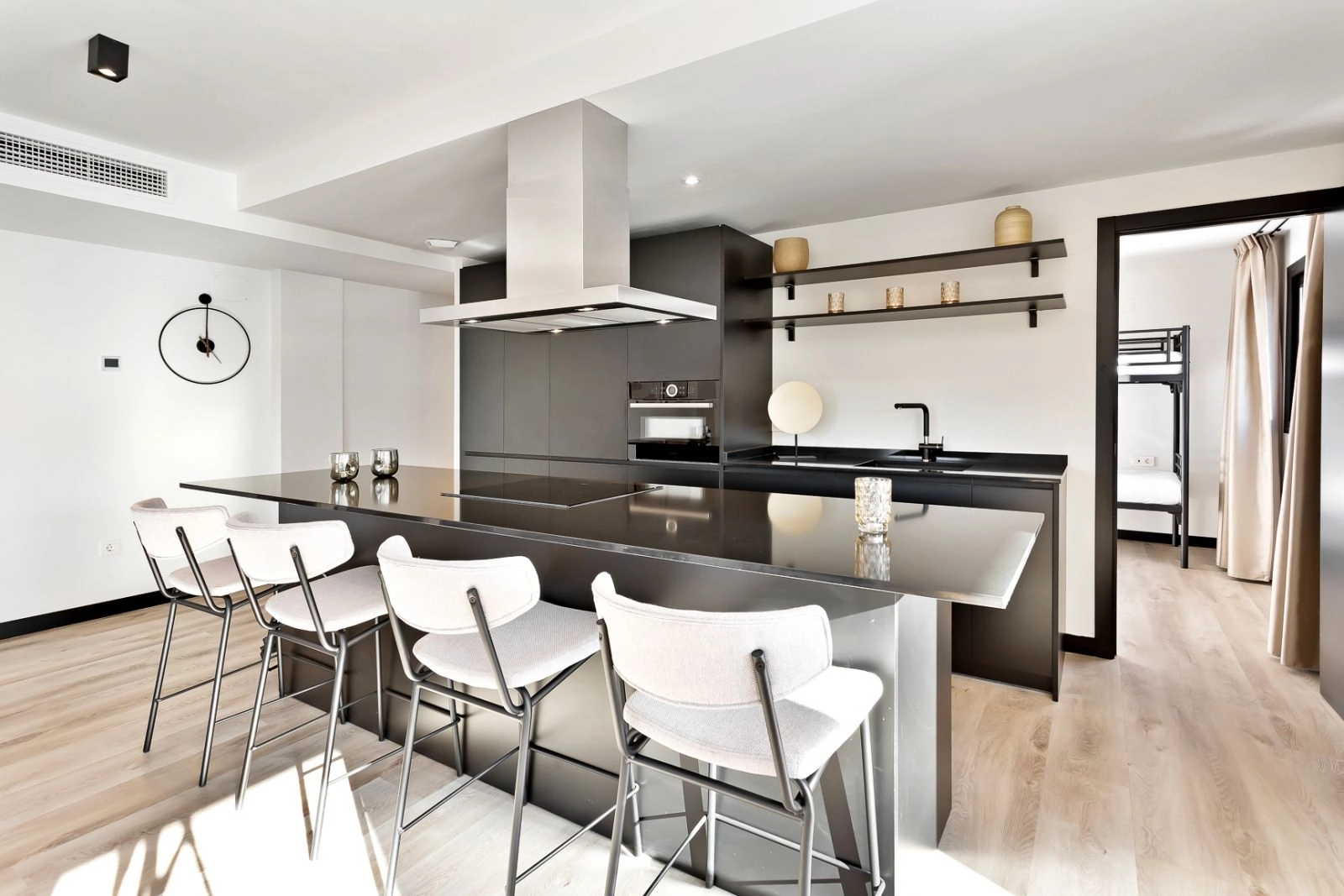 Et elegant, moderne køkken med en central ø og hårde hvidevarer af høj kvalitet, perfekt til hverdagen.