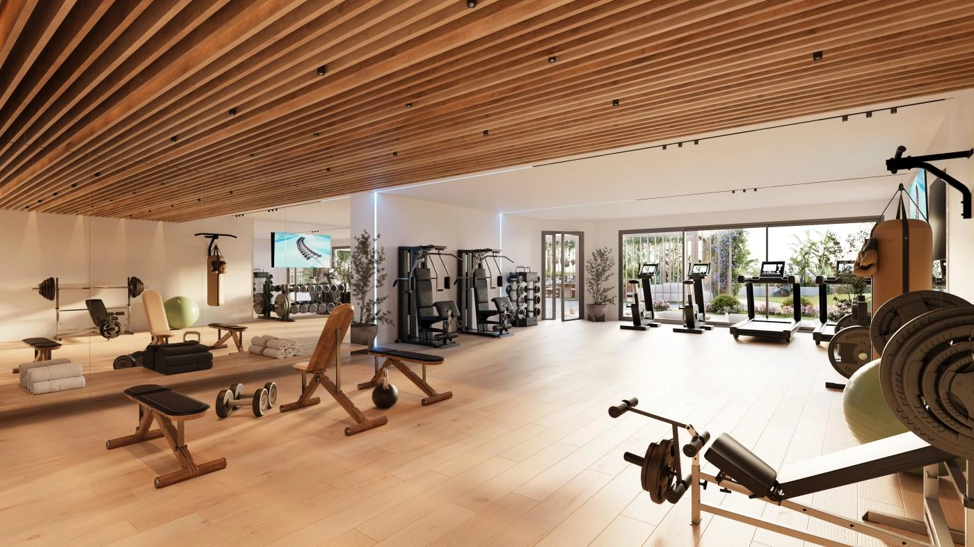 Et topmoderne, fuldt udstyret fitnesscenter med naturligt lys, designet til at understøtte en sund og aktiv livsstil.