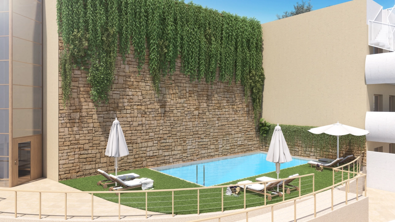 En af de to indbydende udendørs swimmingpools, beliggende i smukt anlagte fælleshaver.