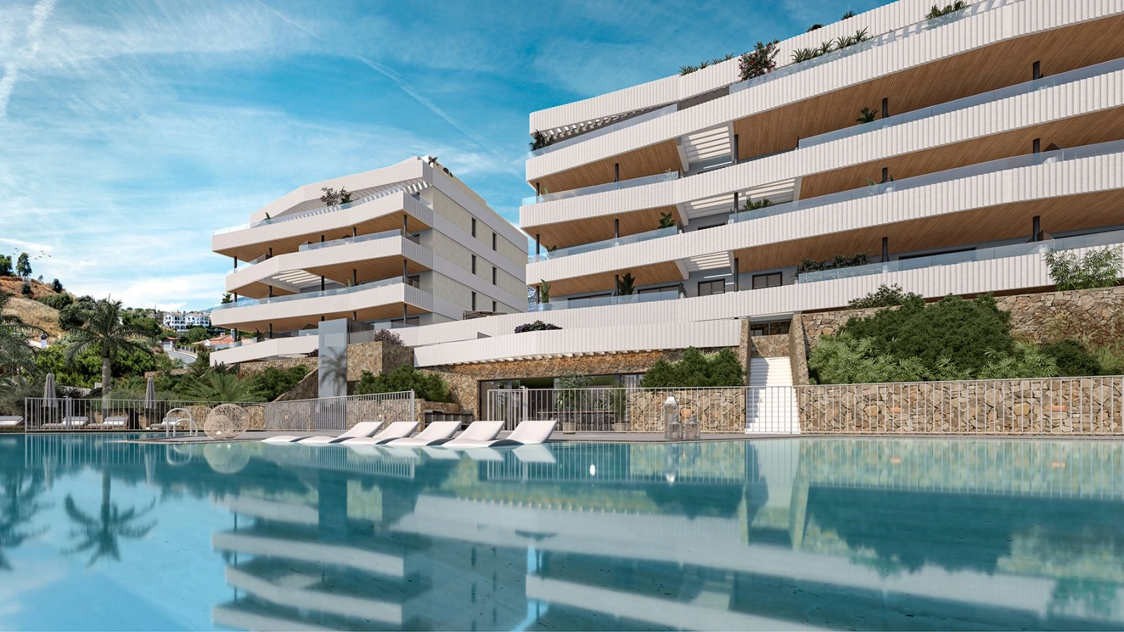 Den indbydende fælles swimmingpool og solbadningsområde, omgivet af moderne arkitektur og frodig beplantning.