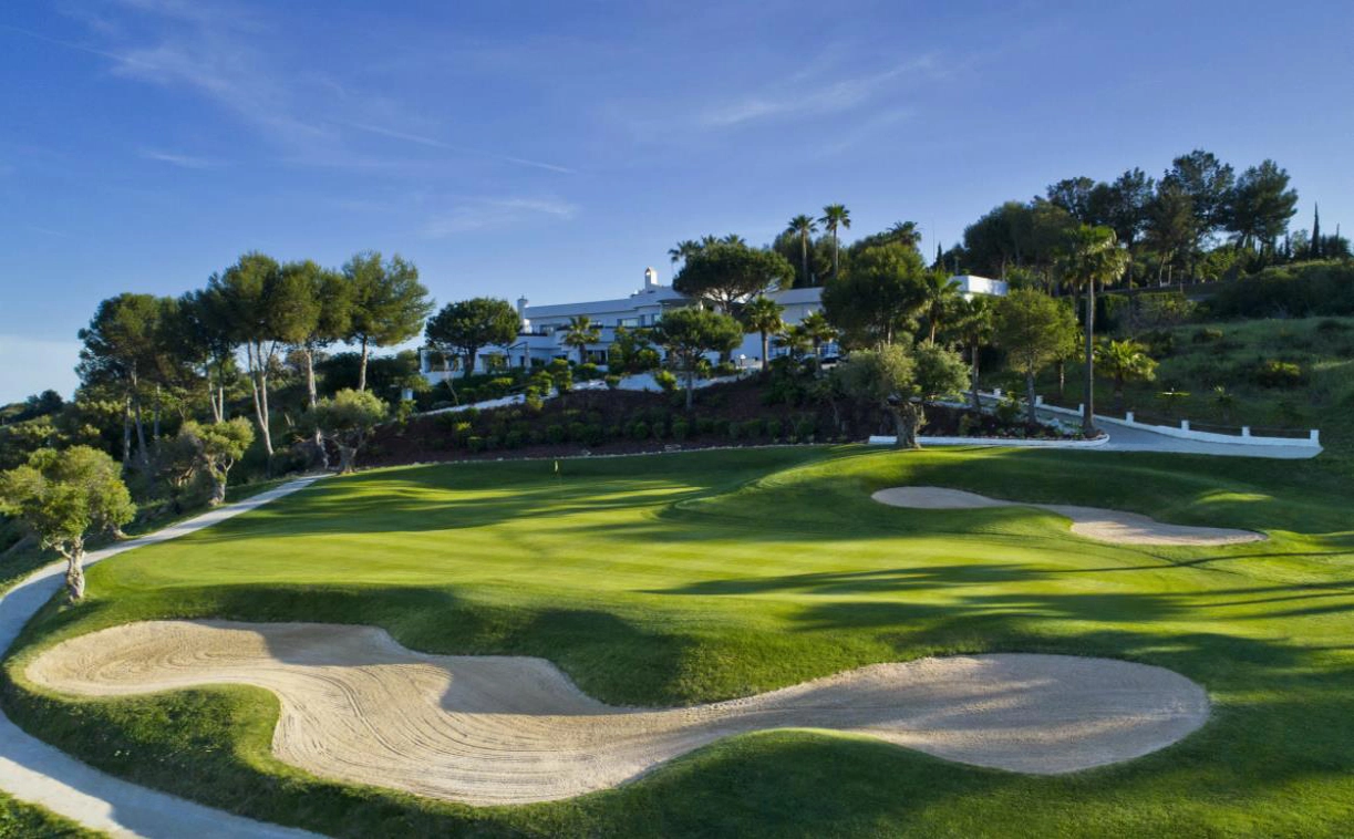 Det prestigefyldte Estepona Golf klubhus, kun en kort gåtur fra din lejlighed, med velplejede greens som baggrund.