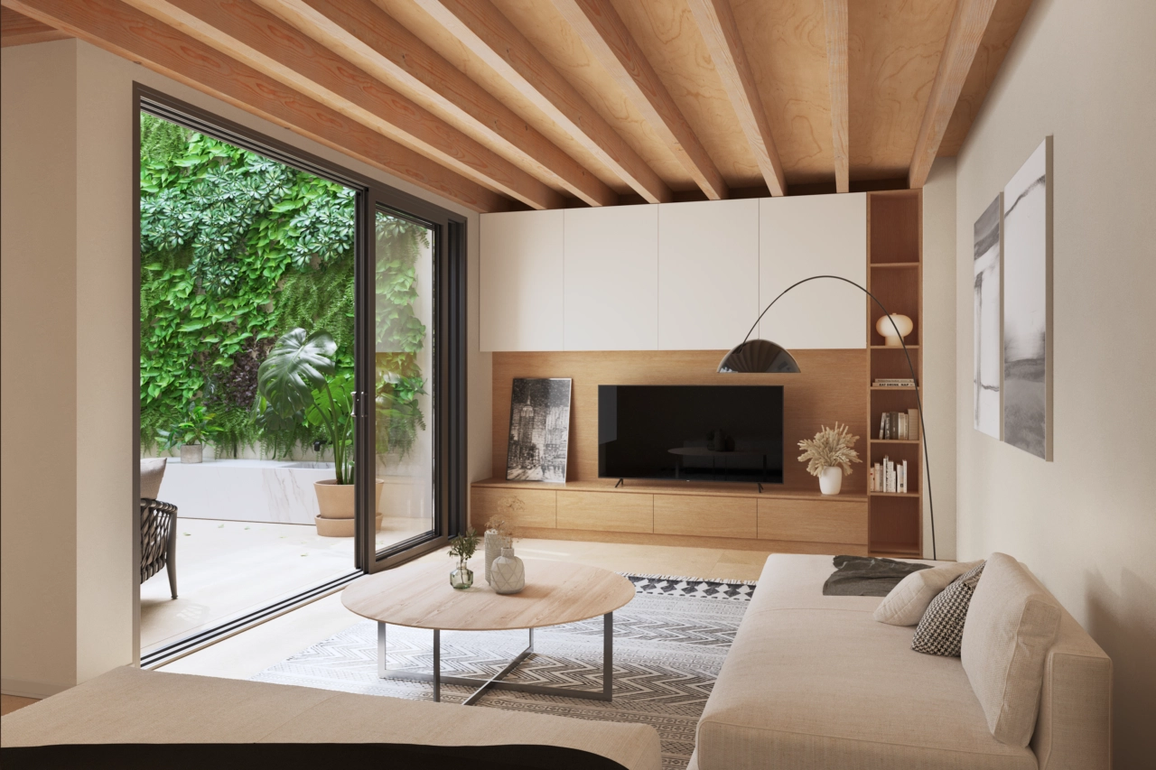 En stilfuld stue vender ud mod den rolige indre gårdhave med en grøn væg.